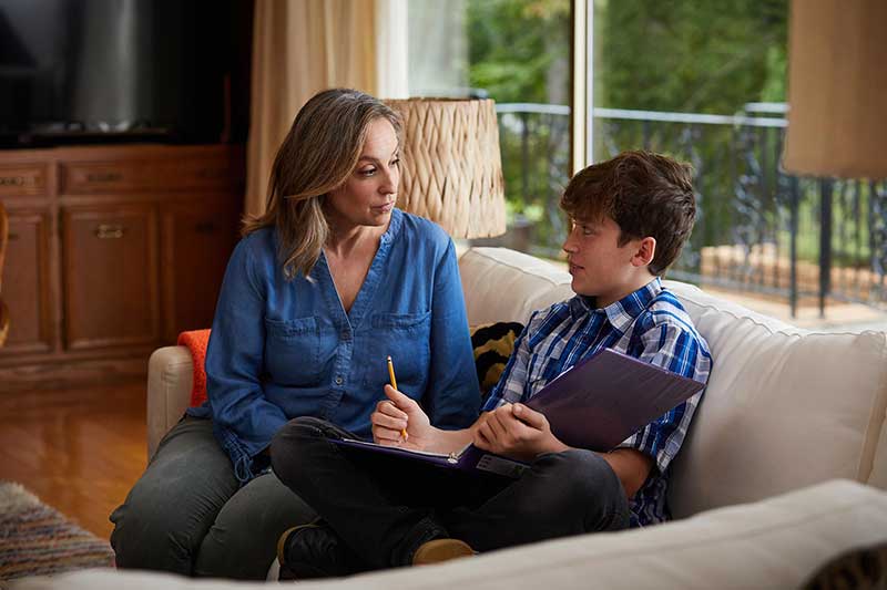 mom talking to son on couch